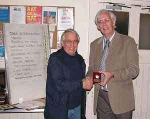 Geoff receives the award from Laurie