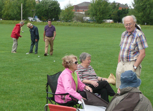 Brian, Laurie and John playing boule while Marion, Audrey and Peter chat