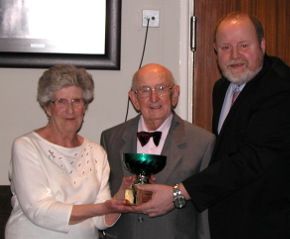 Margaret Burke presents Chas with the novice trophy