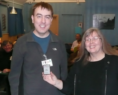 Karen presenting Dave with the mini shield