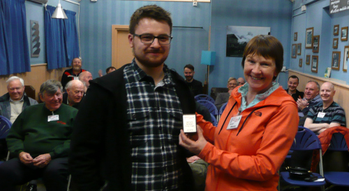 Leon accepts the mini shield from Anne