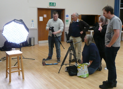 Members filming against a black screen