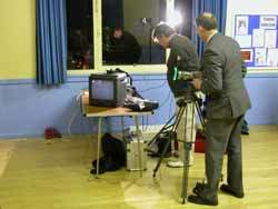 Roger and James studying complex equipment setup